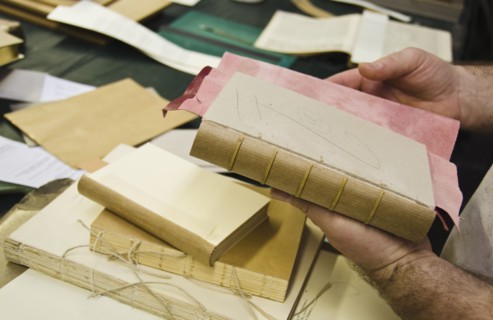 hands binding book.