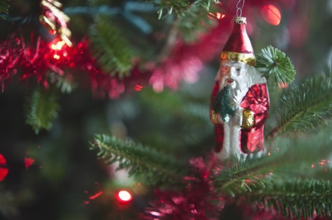 Santa Claus Christmas decoration hanging on Christmas tree, studio shot.