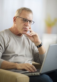 Mature man working on laptop.
