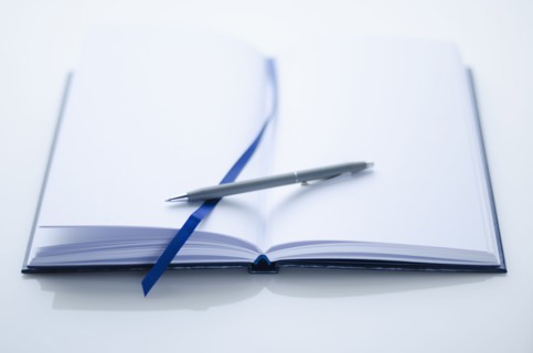 Empty personal organizer and pen.