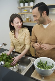 Couple preparing food in kitchen.
