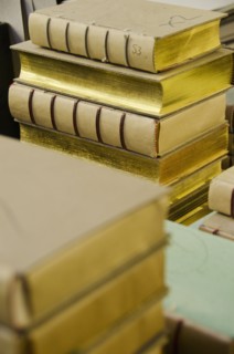 Books stacked in binding workshop.
