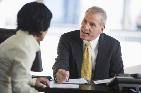 Businesswoman and businessman at meeting.