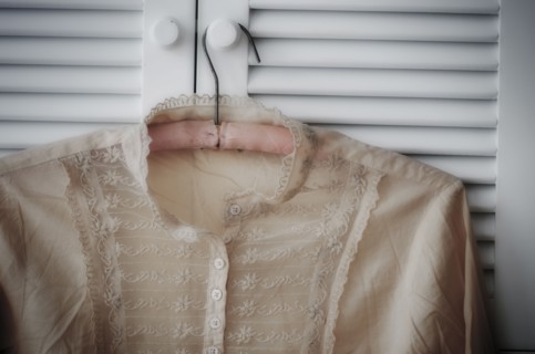 Blouse hanging on wardrobe door.