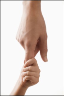 Studio shot of hands of woman and girl (2-3). Photo : Mike Kemp