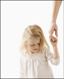 Studio shot of girl (2-3) holding adult's hand. Photo : Mike Kemp