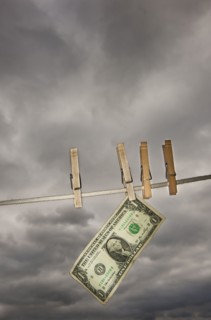 One dollar banknote drying on clothline.