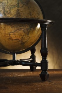 Close up of antique globe on table.
