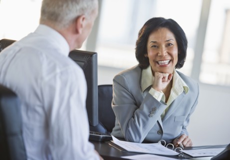Businessman and businesswoman at meeting.