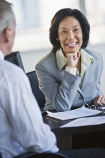 Businessman and businesswoman at meeting.