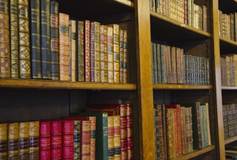 Close up of antique books on shelves.