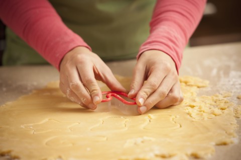 Close-up of girl (6-7) making cookies. Photo : Mike Kemp