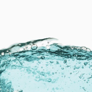 Water with bubbles on white background. Photo : Joe Clark