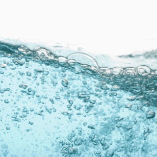 Water with bubbles on white background. Photo : Joe Clark