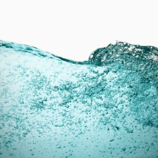 Water with bubbles on white background. Photo : Joe Clark