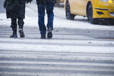 USA, New York City, Pedestrians crossing road in blizzard.