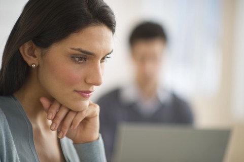 Business woman with hand on chin.