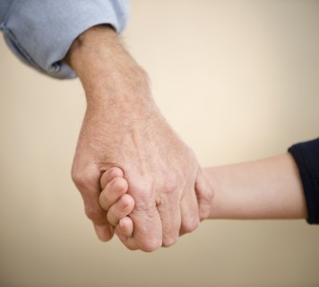 Close up grandfather and grandson (8-9) holding hands. Photo : Jamie Grill Photography