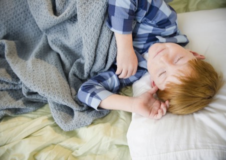 Boy (8-9) sleeping in bed. Photo : Jamie Grill Photography