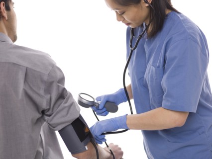 Nurse checking patients blood pressure. Photo : Dan Bannister