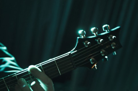 Hand playing guitar.
