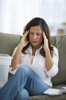 Woman touching head with headache.