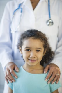 Portrait of smiling girl (6-7) in doctor's office.