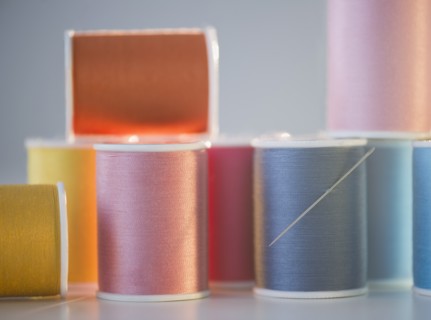 Spools with colorful threads. Photo : Jamie Grill Photography