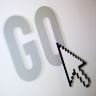 Studio shot of arrow cursor on go button. Photo : Jamie Grill Photography