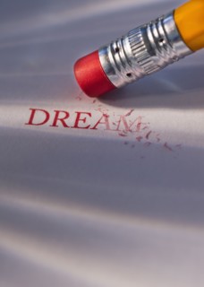 Studio shot of pencil erasing the word dream from piece of paper. Photo : Daniel Grill