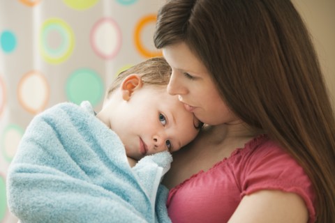 Mother with son (2-3) wrapped in towel. Photo : Mike Kemp