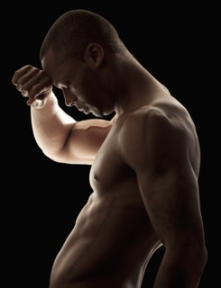 Studio shot of tired shirtless man. Photo : Mike Kemp