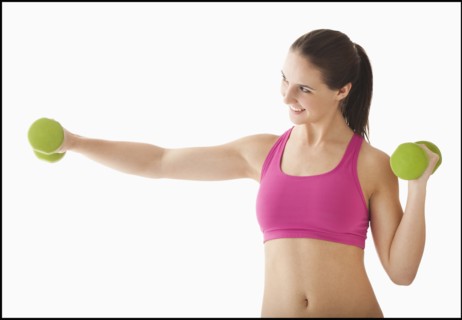 Young woman exercising with hand weights. Photo: Mike Kemp