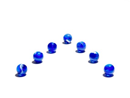 Blue glass balls in a row. Photo : David Arky