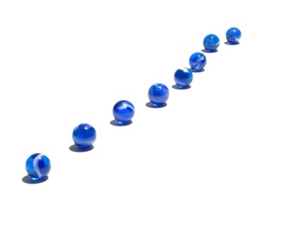 Blue glass balls in a row. Photo : David Arky