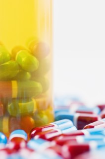 Studio shot of capsules and pill bottle. Photo : Antonio M. Rosario
