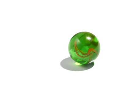Studio shot of small green glass ball. Photo : David Arky