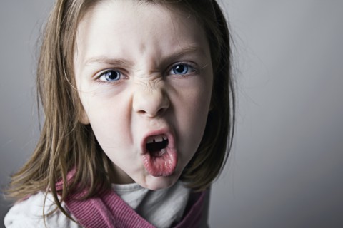 Close-up of girl (6-7) shouting. Photo : Justin Paget