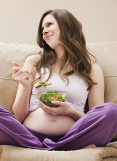 Young pregnant woman eating salad. Photo: Mike Kemp