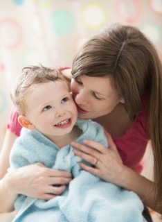 Mother with son (2-3) wrapped in towel. Photo : Mike Kemp