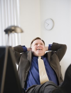 Businessman relaxing in office. Photo: Jamie Grill Photography
