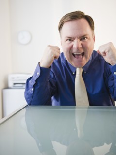 Businessman with clenched fists. Photo: Jamie Grill Photography
