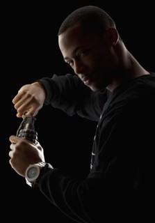 Studio portrait of young man holding grenade. Photo : Mike Kemp