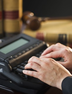 Court stenographer using stenograph machine. Photo : Daniel Grill