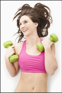 Young woman holding hand weights. Photo: Mike Kemp