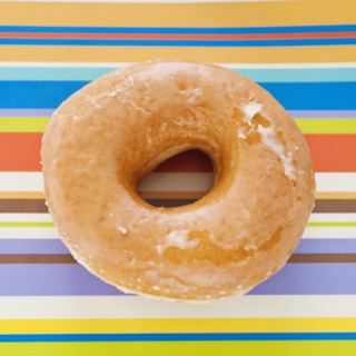 Studio shot of donut on striped background.