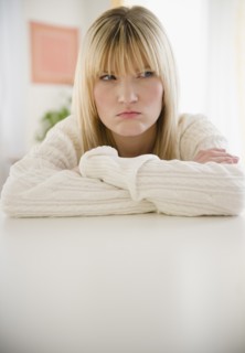 Young woman looking disappointed. Photo : Jamie Grill Photography