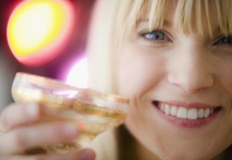 Young woman drinking champagne. Photo : Jamie Grill Photography