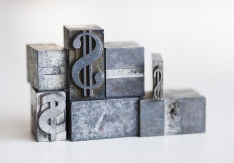 Close up of printing blocks with dollar sign.