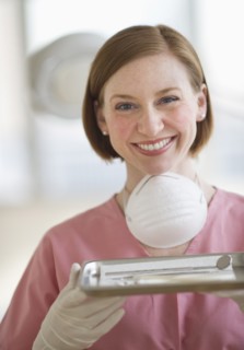 Dental assistant holding tray.
